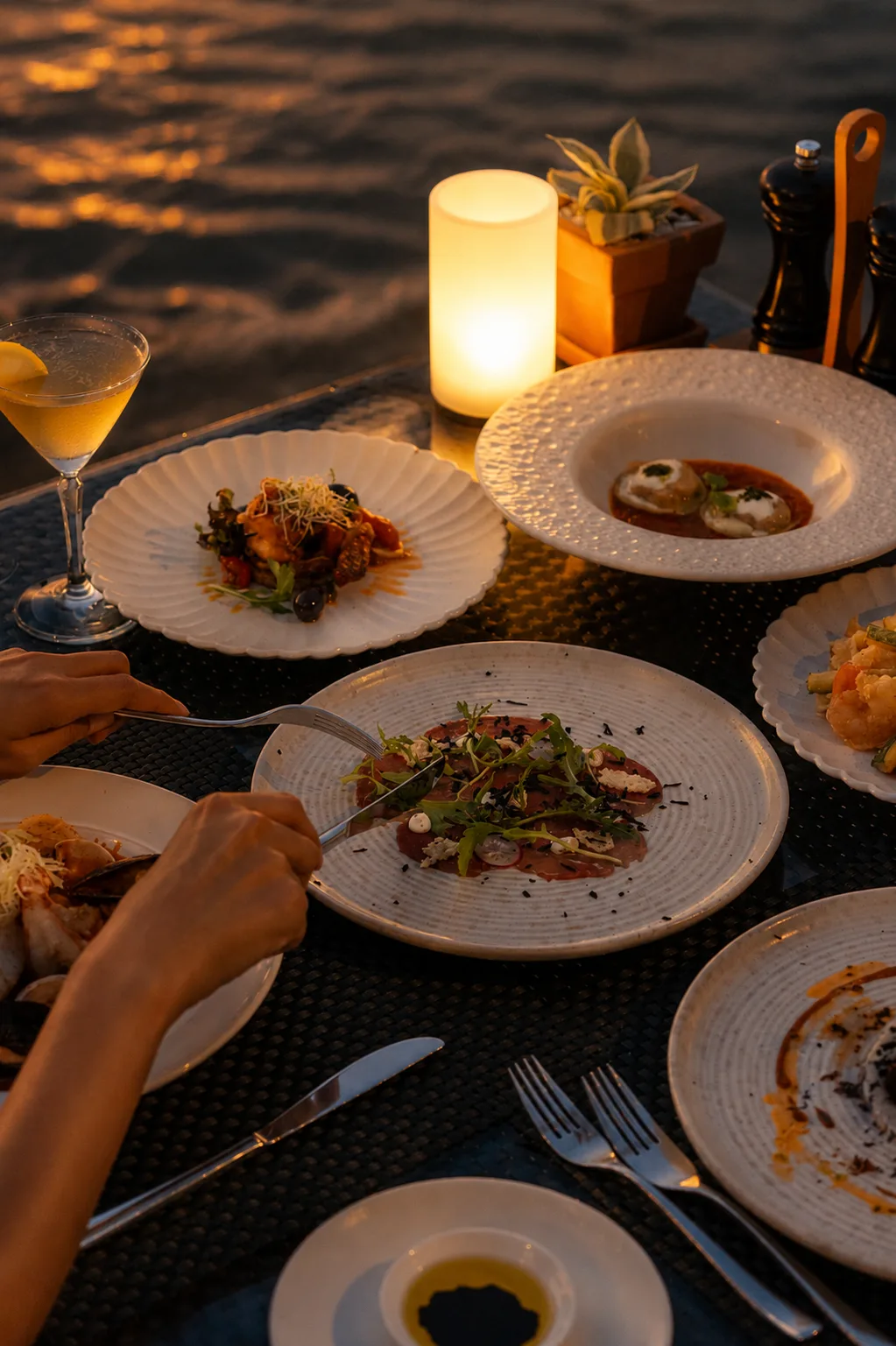 Tuna carpaccio and cocktails at a sunset dinner by the sea