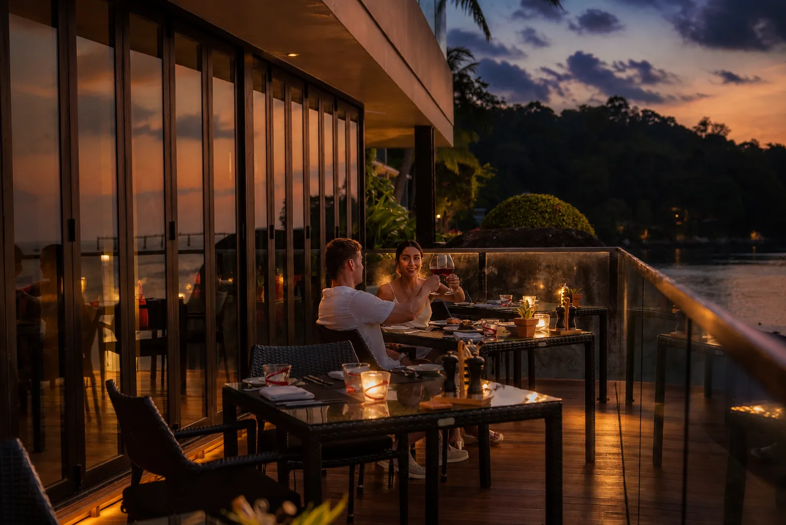 Couple dining on the terrace at dusk, La Gritta