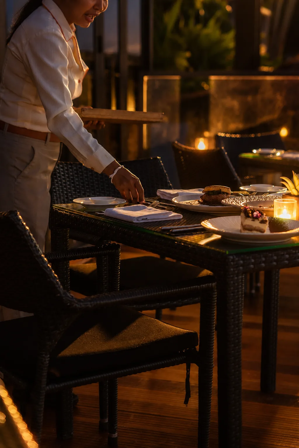 Waitress serving a table at La Gritta in the evening